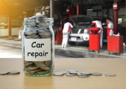 money saving for car repair in the glass bottle