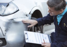 insurance adjuster is inspecting car accident claims