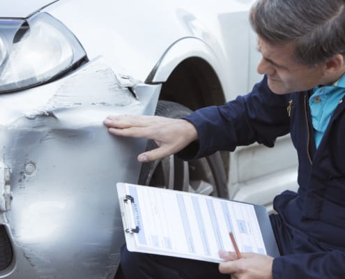 insurance adjuster is inspecting car accident claims