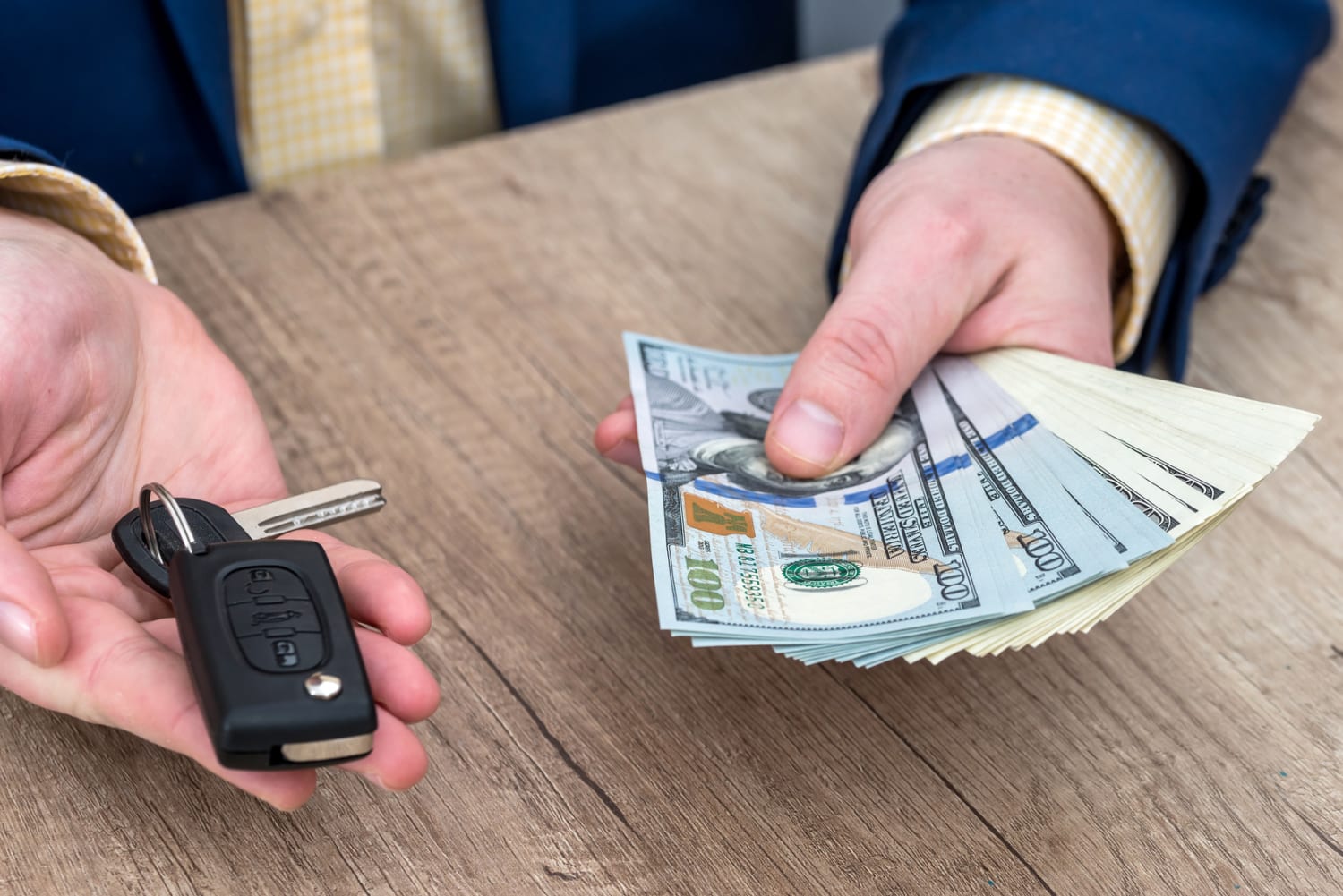 Businessman holding car key and money