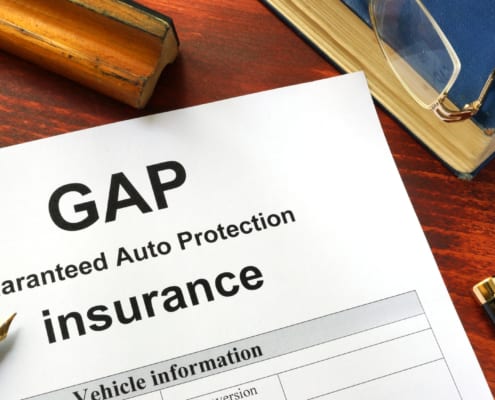 GAP insurance form on a table with a book.